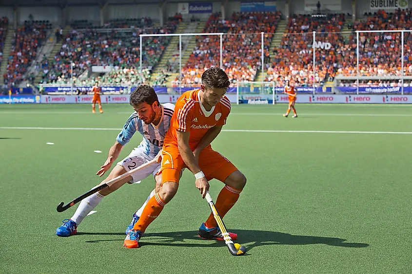 Hockey player Kemperman (NED) fencing off Brunet (ARG) during a charge at the Hockey World Cup.