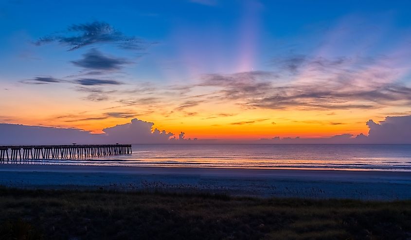 Sunrise over the Atlantic Ocean and the Jacksonville Beach pier in Jacksonville Beach Florida USA